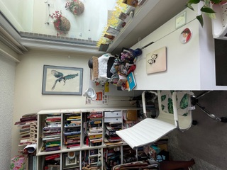 A white desk and chair inside Janice MacDonald's writing studio.