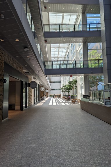 A corridor in the University of Toronto MaRS building. Two pedestrian bridges stretch over the main corridor.