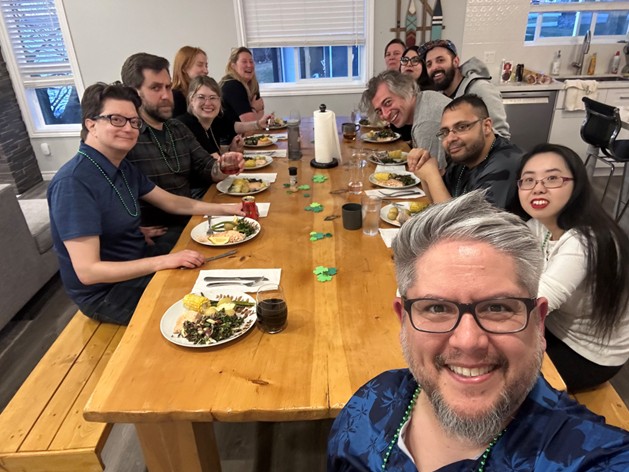 A group selfie of Don Miasek (front left) having dinner with eleven other writers.